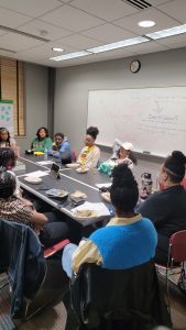 Conversation participants having a discussion as a group at a table